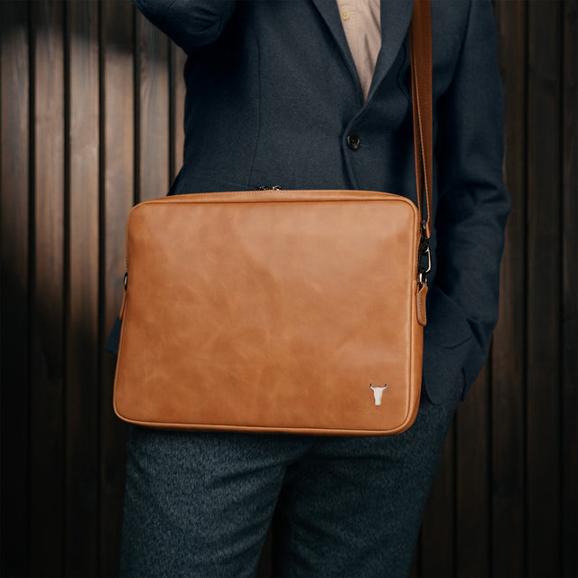 Man carrying the Tan Leather Messenger Bag