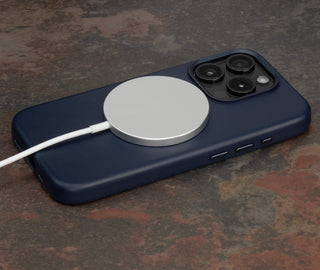 MagSafe charger attached to the Navy Blue Slimline Leather Bumper Case for iPhone 15 Pro