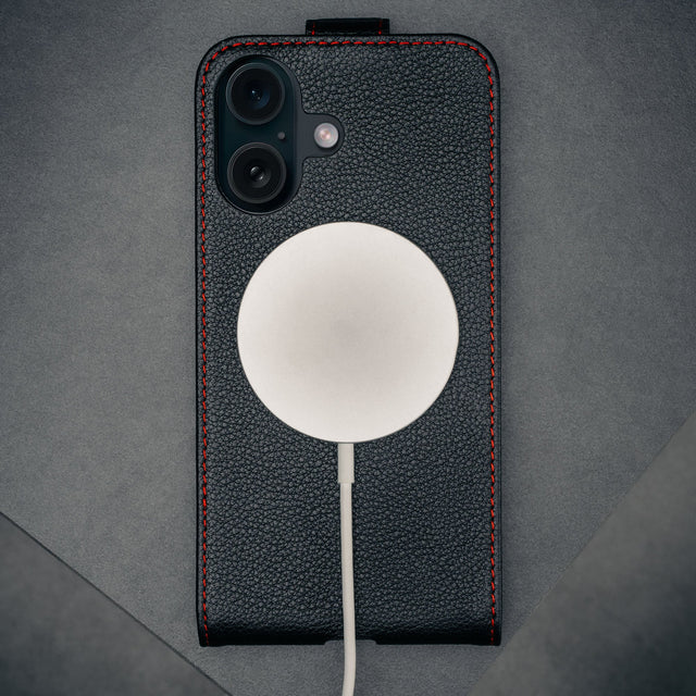MagSafe charger attached to the Black with Red Stitching Leather Flip Case for iPhone 16