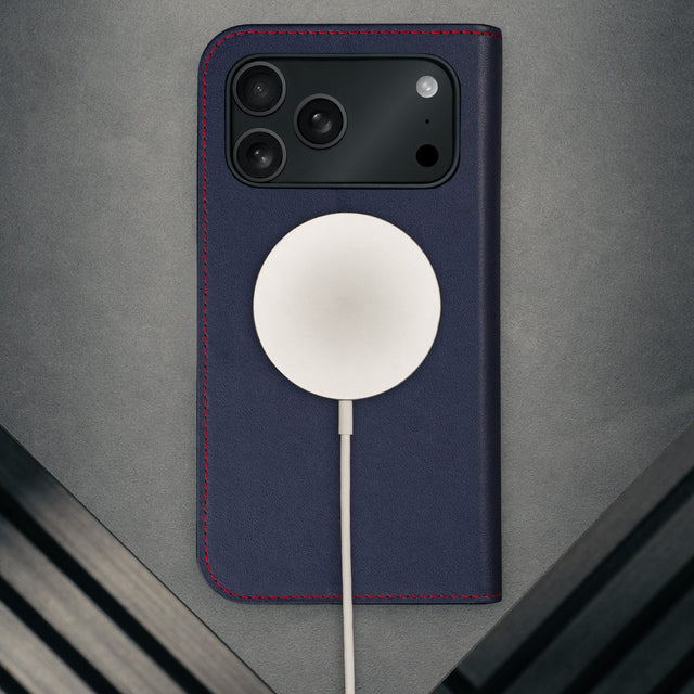 MagSafe charger attached to the Navy Blue Leather Case (with Red Stitching) for iPhone 17 Pro Max