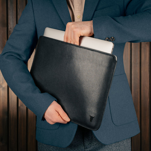 Man taking laptop out of the Black Leather MacBook Pro / MacBook Air Sleeve Case