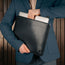 Man taking laptop out of the Black Leather MacBook Pro / MacBook Air Sleeve Case