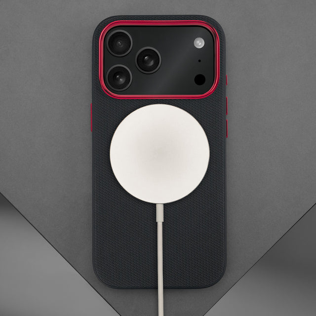 Wireless charger attached to the Black with Red Detail Woven Texture Bumper Case for iPhone 17 Pro